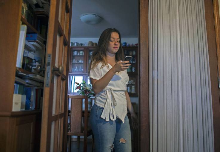 A high school student and former patient of “Delete,” a therapy group for children with “nomophobia” (fear of being left without a mobile phone.jpg