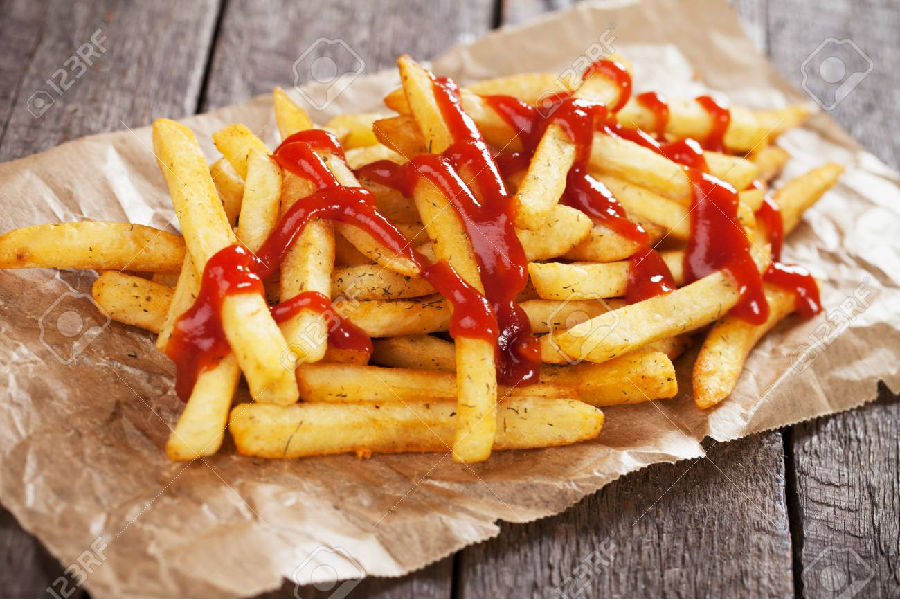 84122713-french-fries-with-ketchup-served-on-parchment-paper.jpg